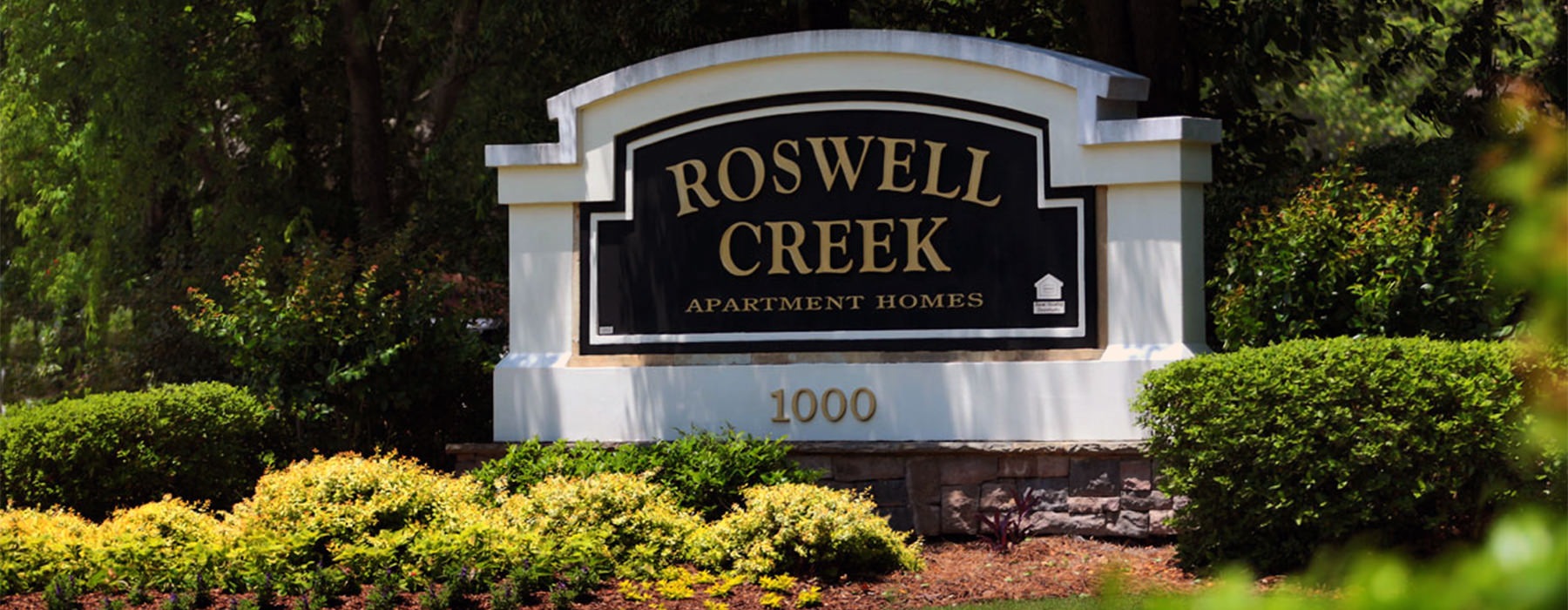 Roswell Creek Entrance sign with beautiful landscaping